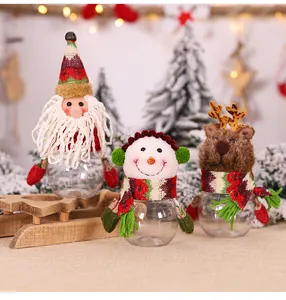 Three Christmas candy jars with Santa, Snowman and Reindeer on a festive background