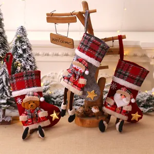 Three-piece Christmas stocking set featuring 3D Santa, Snowman and Bear on red plaid fabric
