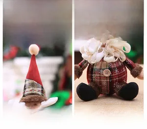 Detailed view of handmade plush Christmas gnome with red felt hat and plaid fabric texture