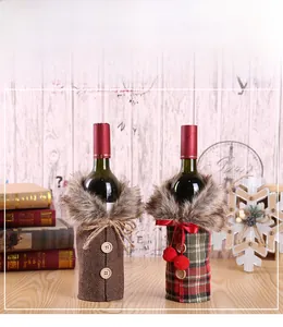 Close-up of Christmas wine bottle covers with faux fur collars and festive plaid patterns