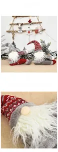 Close-up of red and grey knitted Christmas gnome dolls with dense white beards for home decor