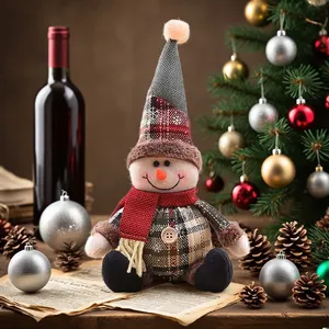 Cute snowman plush Christmas tree ornament with gray snowflake hat and plaid outfit