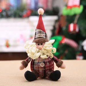 Classic sitting Santa plush ornament with red plaid hat and festive Christmas tree background