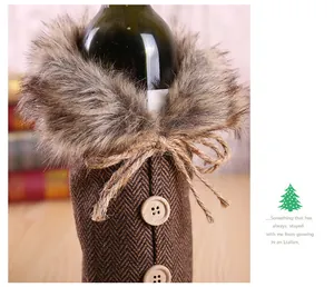 Detail of Christmas wine bottle cover with faux fur collar and jute bow tie decoration