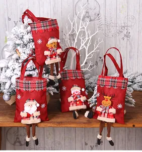 Detailed view of four Christmas linen gift bags with festive 3D cartoon characters