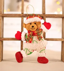 Detail of Christmas teddy bear ornament in plaid hat on a warm wooden background