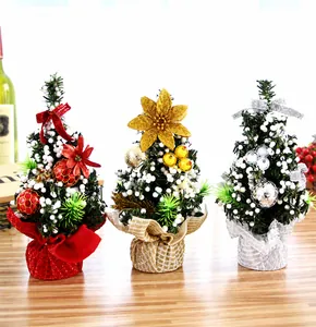 Detailed view of three mini 20cm Christmas trees in red, gold, and silver for desk decor