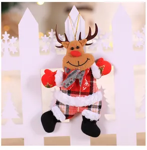 Detail view of plush reindeer Christmas ornament with red plaid outfit and golden string