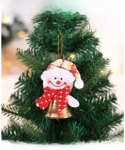 Detail of Christmas snowman pendant with plush fabric hat and gold bell on a tree