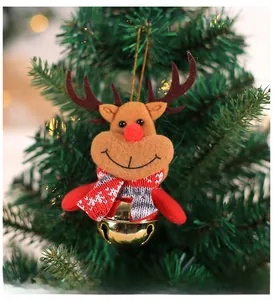 Detail of Christmas reindeer felt ornament with a golden bell on a holiday tree