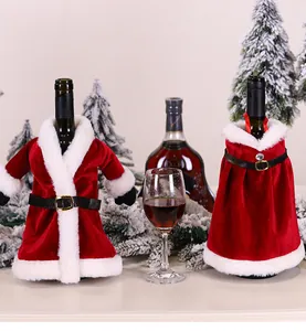 Detail of red velvet Christmas wine bottle covers with white faux fur trim and black belt