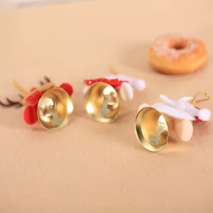 Golden Christmas bells with plush reindeer antlers and red balls for festive tree decor
