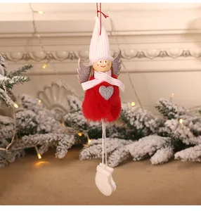 Close-up of red plush angel doll with silver sequin heart and wings for Christmas trees