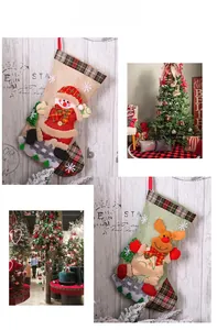 Detail of Christmas stockings with plaid burlap, gnome and reindeer appliques on white wood