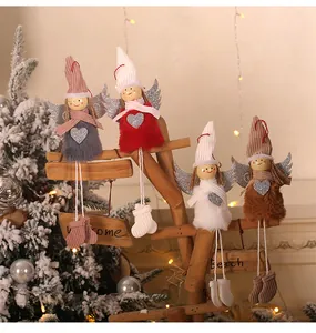 Detail of four colorful plush Christmas angel dolls with knit hats and silver glitter wings