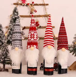 Close-up of four knitted Christmas gnome wine bottle covers with various festive patterns