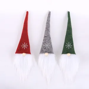 Three Nordic Christmas gnomes with long hats and white beards for festive holiday decor