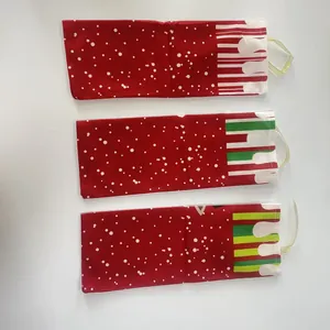 Detailed view of three festive red Christmas wine bottle bags with white polka dots