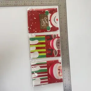Detail view of festive Christmas wine bottle covers with Santa and reindeer motifs