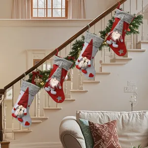 Christmas stocking set with gnomes hanging on staircase banister for festive decor