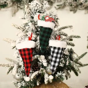 Christmas plaid cutlery bags with red truck decor hanging on a snowy Christmas tree