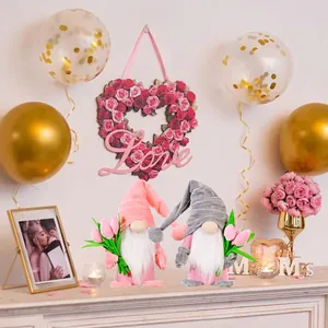 Set of two plush Nordic gnomes holding pink tulip bouquets for Mother's Day decor