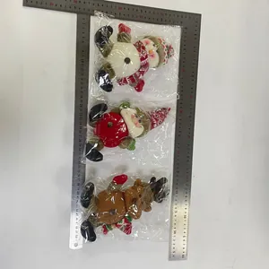 Close-up of Santa, Snowman, and Reindeer plush ornaments with dimension ruler measurement
