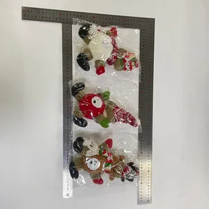 Three plush Christmas reindeer gnomes with knit scarves and hats in transparent packaging