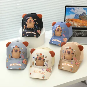Flat lay of five kids baseball caps with 3D capybara ears and cartoon prints