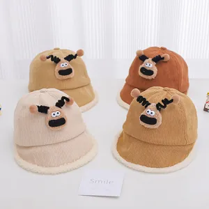 Detailed view of four corduroy children fisherman hats with cartoon reindeer designs