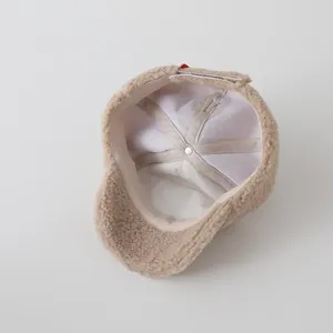 Detailed interior view of kid's plush baseball cap showing white twill lining and stitching