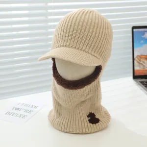Close-up of beige knitted balaclava hat with soft brown plush lining and sun visor detail