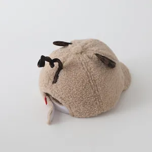 Detail of baby plush baseball cap showing fleece texture and adjustable velcro strap
