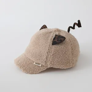 Close-up of plush beige kids baseball cap with leopard ears and fluffy texture
