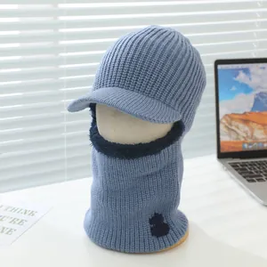 Detail of blue knitted balaclava with warm plush lining and cute cat embroidery patch