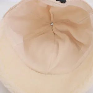Detailed macro view of the soft beige fleece lining and durable inner stitching of the hat