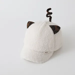 Detailed view of white sherpa baseball cap with leopard ears and spiral tail detail