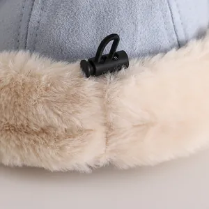 Detailed close-up of blue fabric texture with beige faux fur lining and adjustable cord