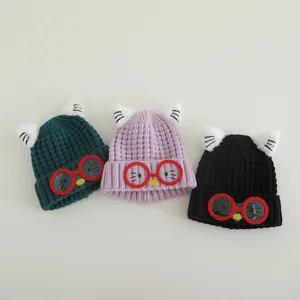 Kids knitted beanie hats with cat ears and glasses in dark green, purple, and black