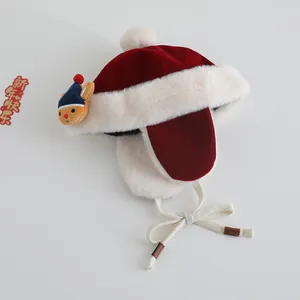 Red baby winter pilot hat with white pompom and plush deer detail for Christmas warmth