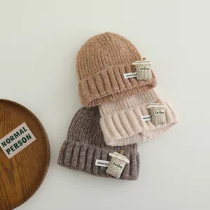 Cozy knit winter hat for kids with cartoon coffee cup patch in warm earth tones