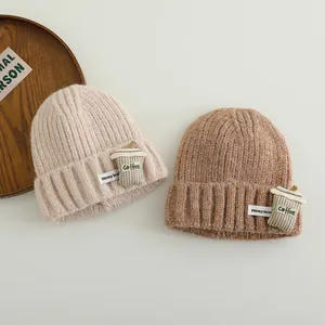 Close-up of knit winter beanie with 3D coffee cup patch and Honey Bear label detail