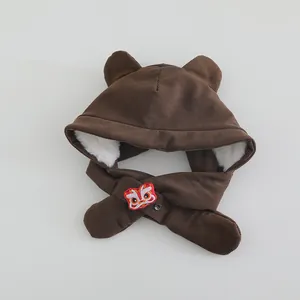 Detail of dark brown corduroy kids hood with bear ears and lion dance embroidery
