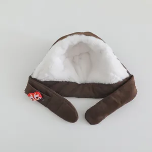 Detail view of brown corduroy winter hat with plush lining and red lion dance embroidery