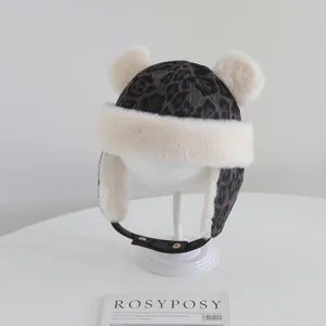 Detail of leopard print winter hat with plush faux fur trim and adjustable chin strap