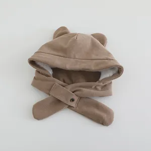 Detail of baby winter hood with brown corduroy texture, plush lining, and cute animal ears