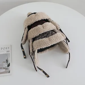 Detail of warm leopard print baby winter hat with plush earflaps and chin straps