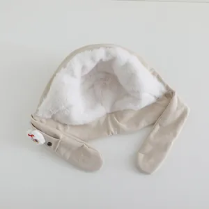 Detail of children's warm beige trapper hat with thick faux fur lining and corduroy fabric