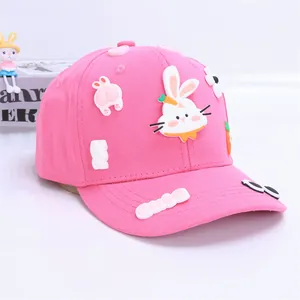 Detail of pink kids baseball cap featuring 3D cartoon bunny patches and cute letter embroidery