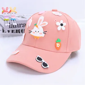 Detail of pink cartoon baseball cap with 3D bunny, carrot, and flower patches for kids